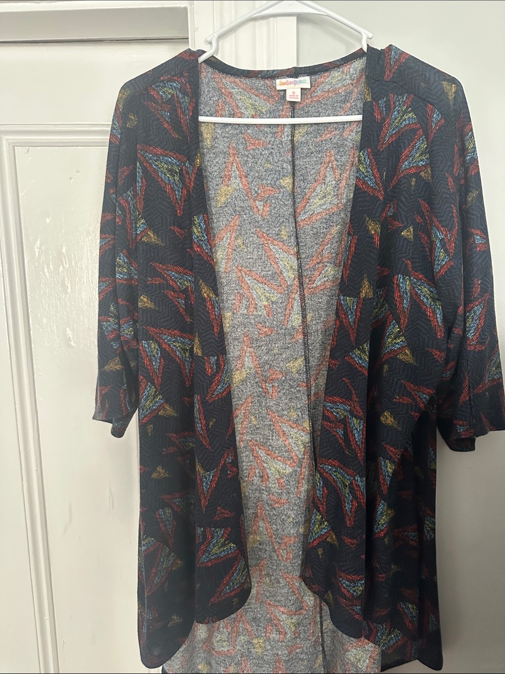 LuLaRoe Black Open-Front Cardigan with Red, Blue, Yellow Feather Motif